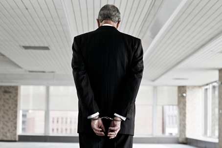 Businessman in handcuffs.