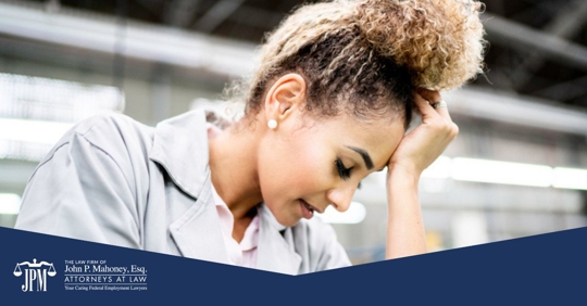 employee holding her head