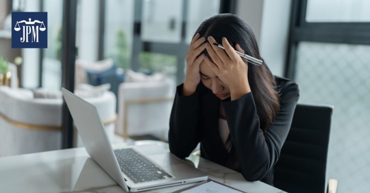 employee with her face on her hands